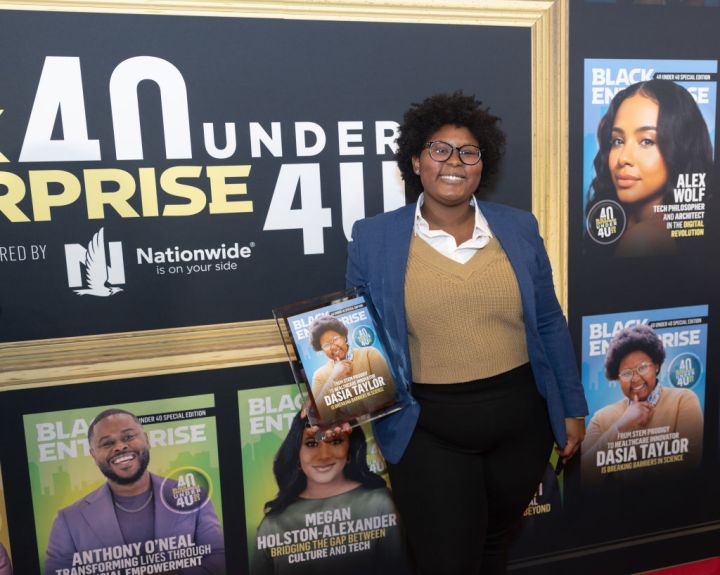 Dasia Taylor holding her cover of the Black Enterprise '40 Under 40: Class Of 2023' issue