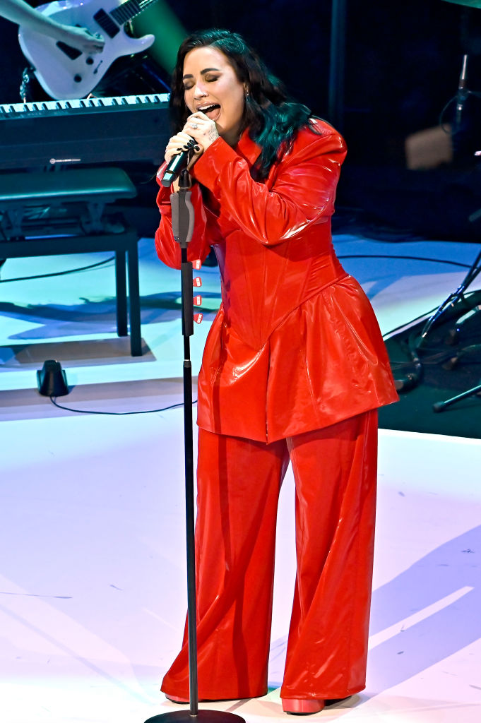 Headliner Demi Lovato performs in a custom red pantsuit at the 2024 "Go Red for Women" Red Dress Collection Concert