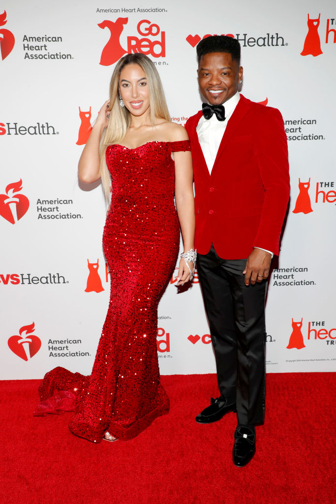 Brooke Hall and Marco Hall on the red carpet at the 2024 "Go Red for Women" Red Dress Collection Concert