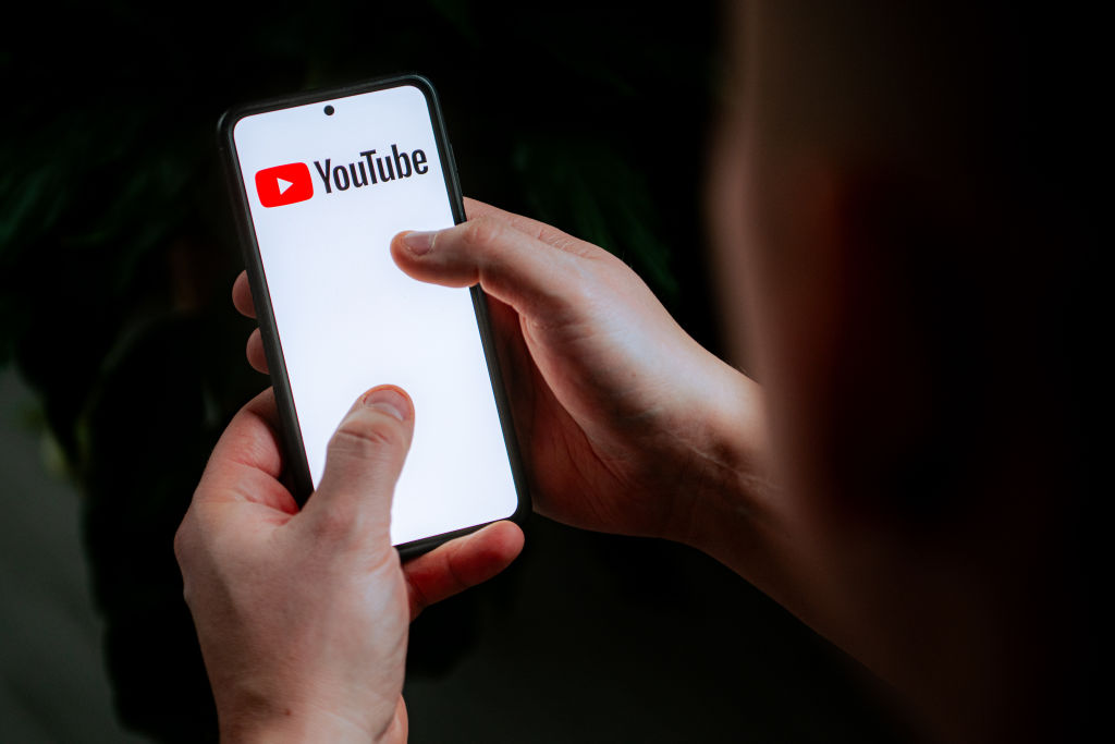 In this photo illustration a YouTube logo seen displayed on...