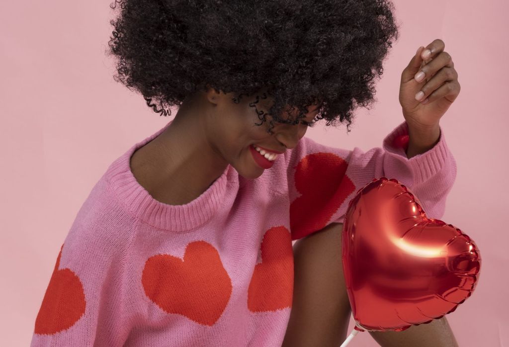 Beautiful black woman with balloon heart.