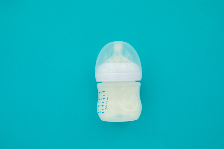 Close-up of light bulb over blue background