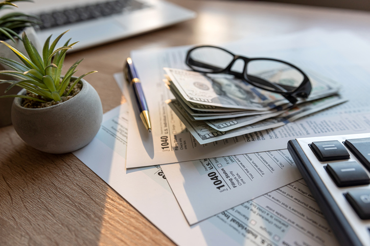 Form 1040 with pen and glasses, tax payment