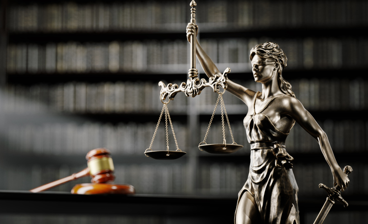 Legal Concept: Themis is the goddess of justice and the judge's gavel hammer as a symbol of law and order on the background of books