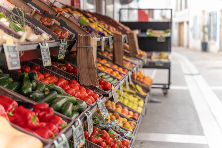 Fresh produce displayed on a market vendor's stall for sale