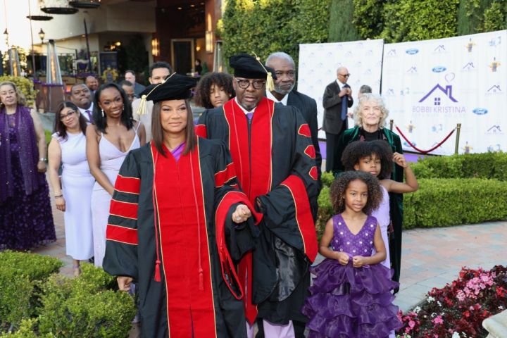 Bobby and Alicia are escorted by family and loved ones while accepting their honorary degrees