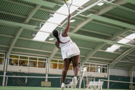Female Tennis Player Hitting Ball