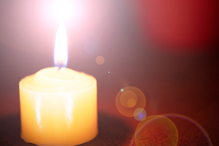 Orange bokeh with lens flare on candles burn lights for background