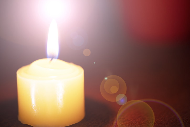 Orange bokeh with lens flare on candles burn lights for background