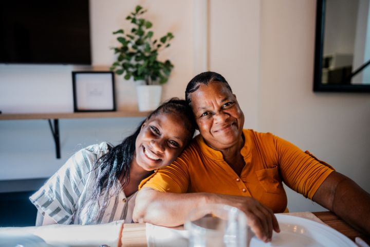 Portrait of grandmother and granddaughter at home