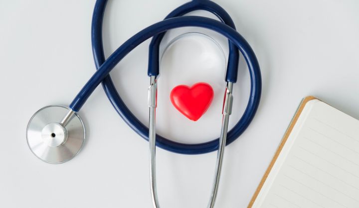 The concept of family insurance and medical care. a stethoscope and a heart figurine