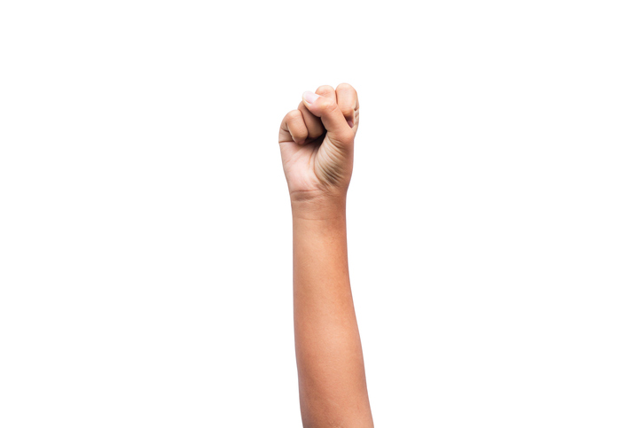 Hand raised fist isolated on white background.