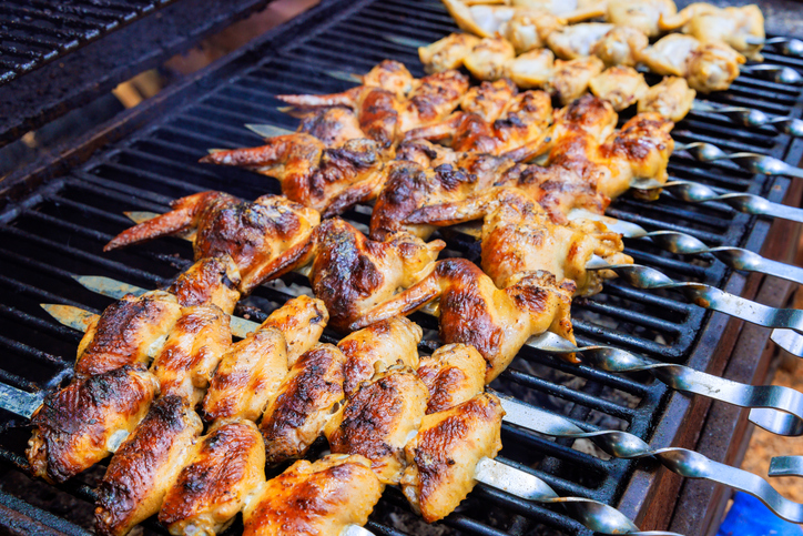 Grilled chicken wings on a charcoal barbecue are typical of American cuisine