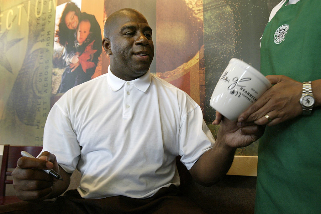 Earvin "Magic" Johnson celebrates the grand opening of his Starbucks in Compton Saturday morning wit