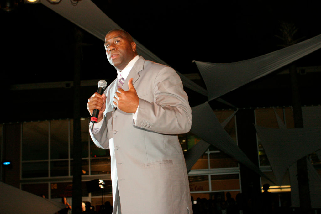 A retired basketball player speaks at the Magic Johnson Foundation, benefit fashion show.