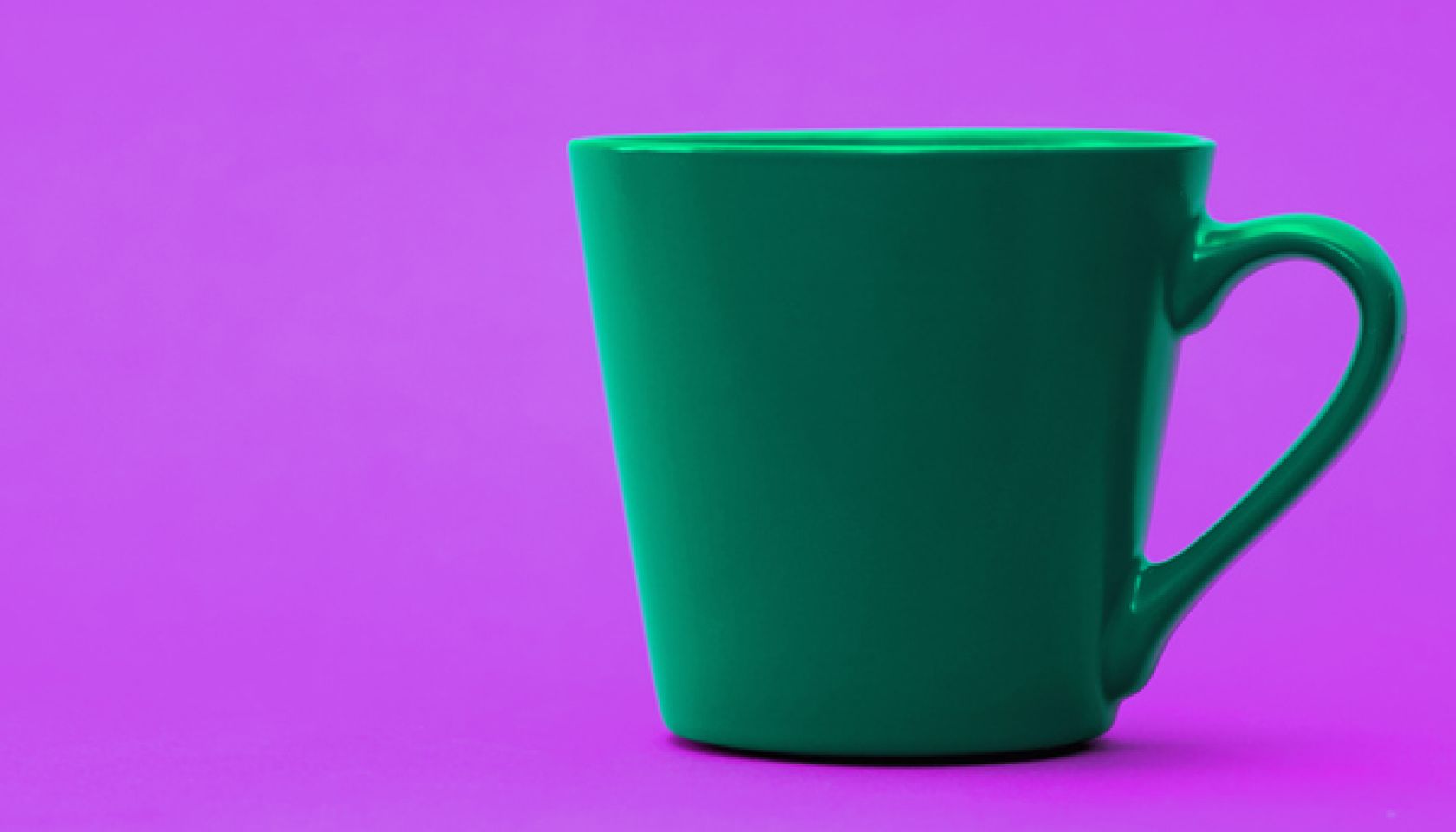 Green mug on purple neon background