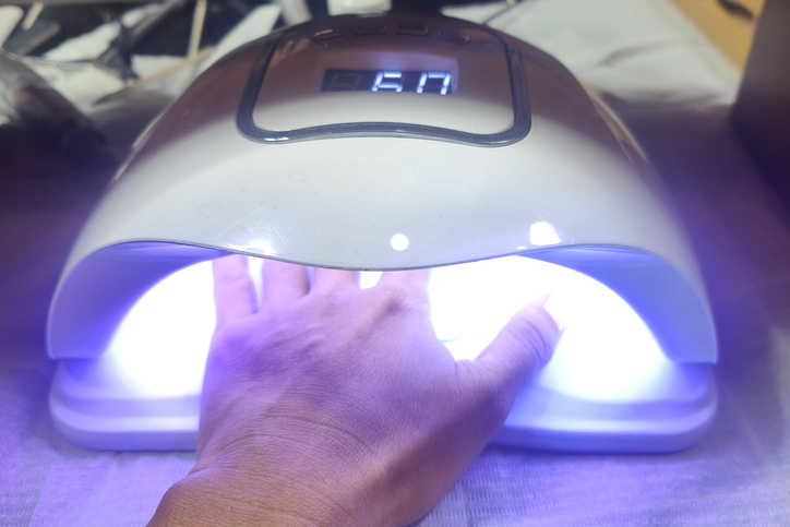 UV Nail Lamp Drying Gel Polish on Hand