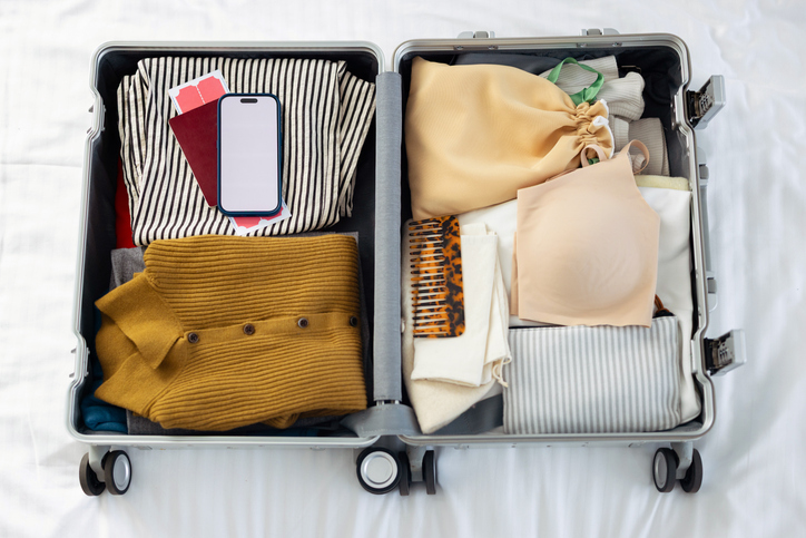 Packed Carry-On Suitcase With Clothes and Travel Essentials