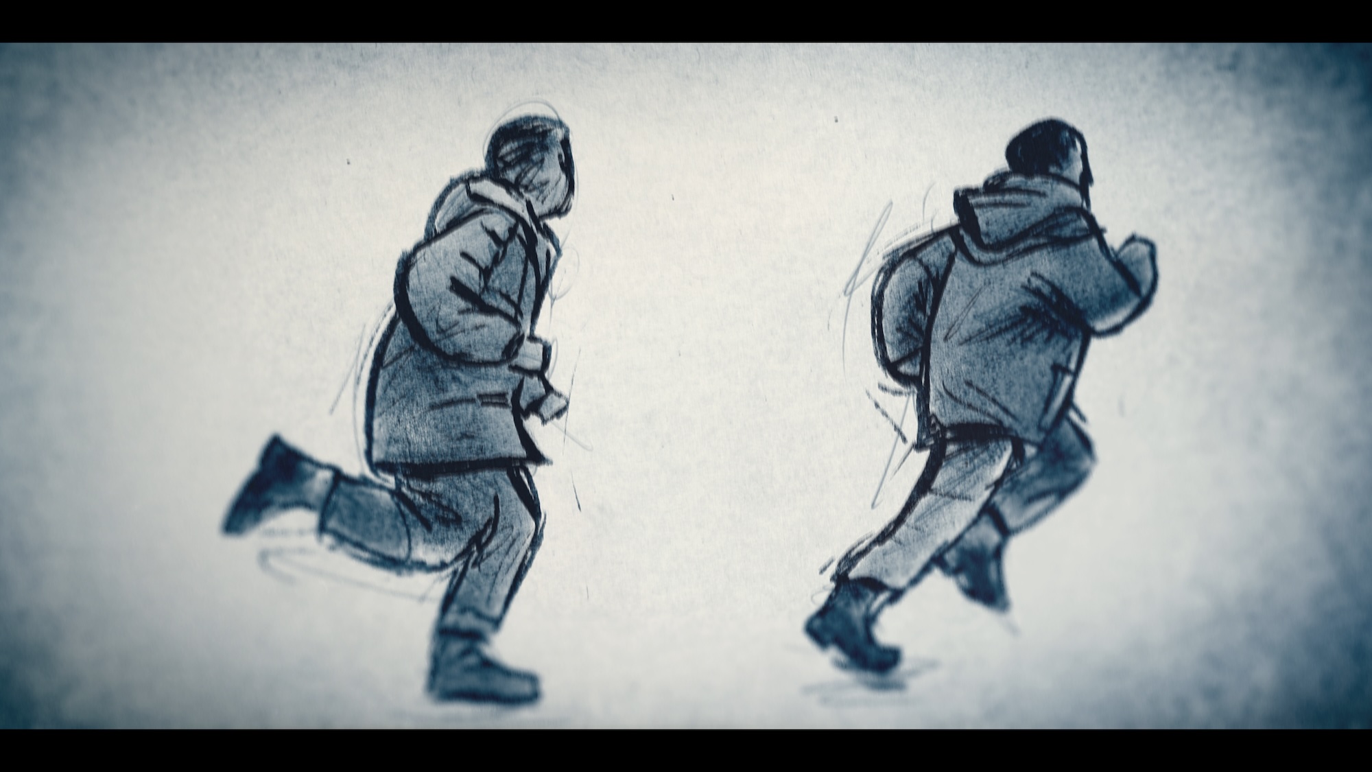Two people in winter coats walking in a snowy, blurred outdoor setting.