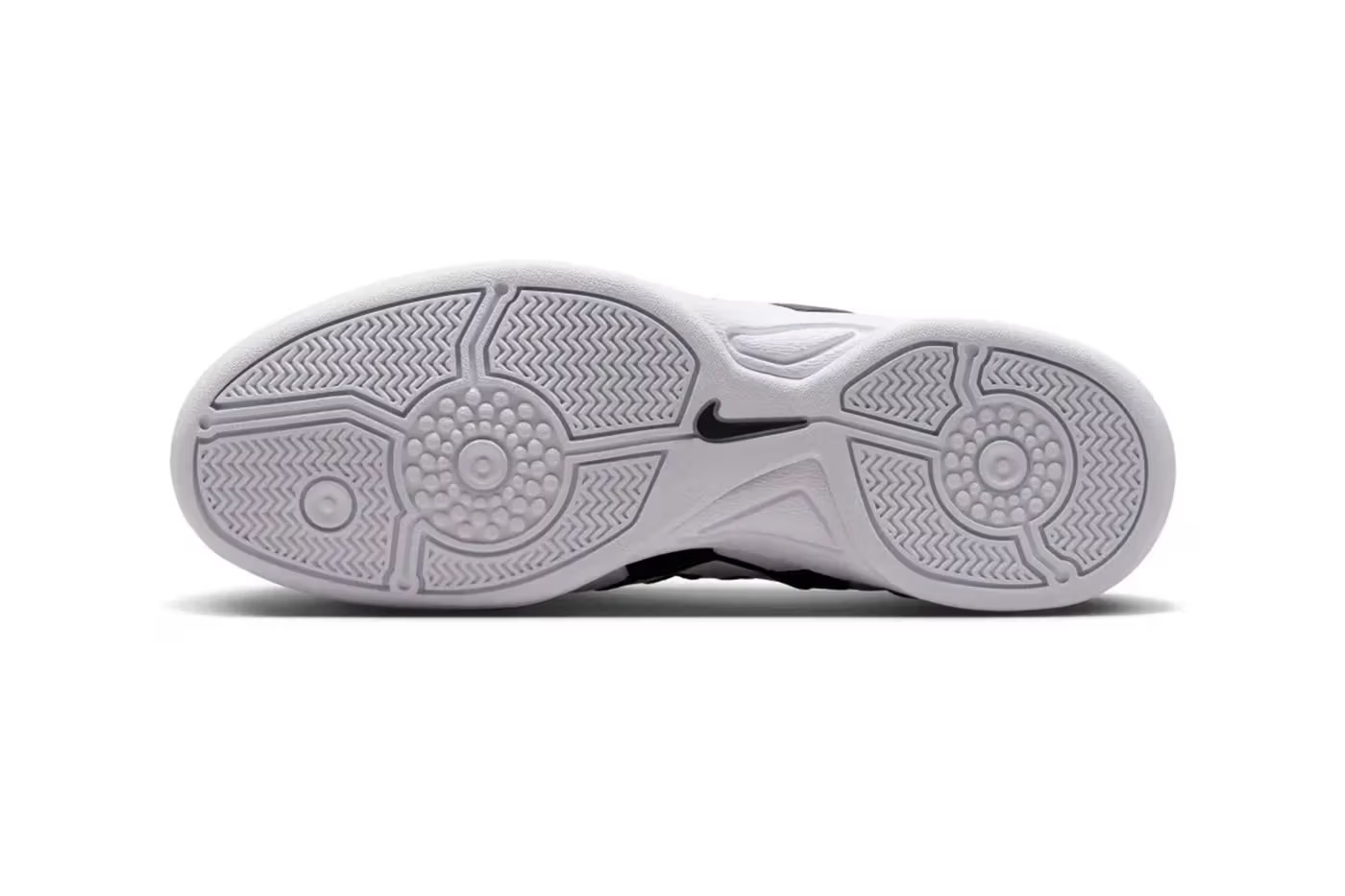 Close-up of a white and black Nike basketball shoe sole with a distinctive tread pattern.