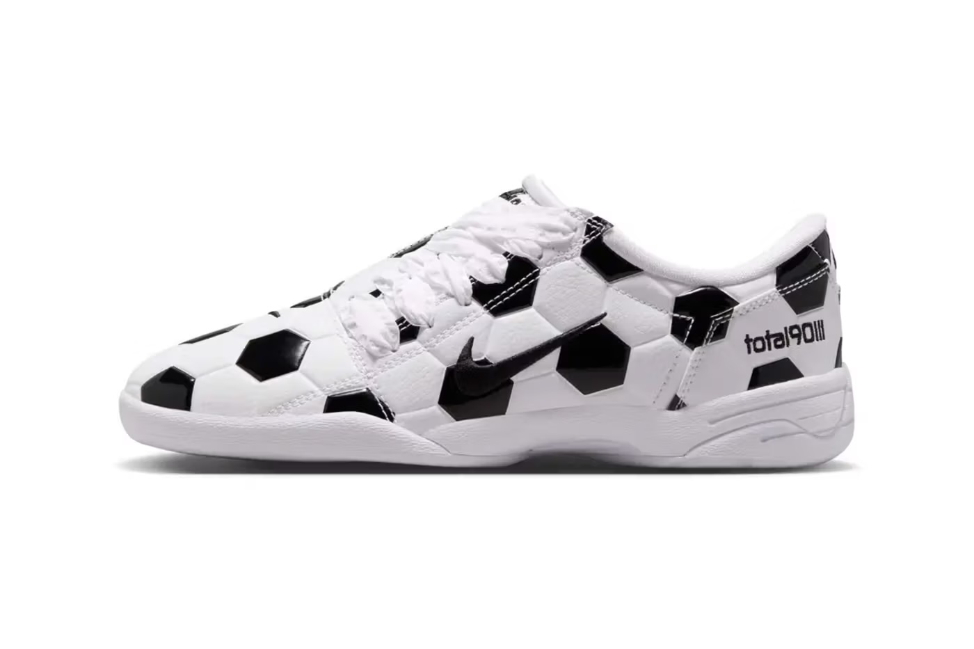 A pair of white and black soccer-themed sneakers with a repeating hexagon pattern.