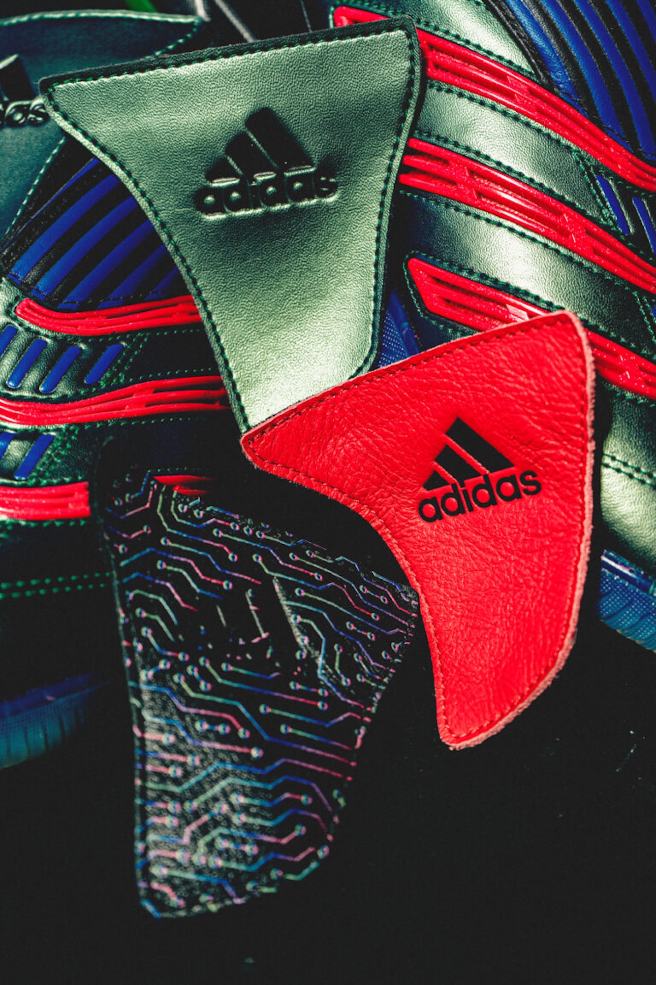 Closeup of a green and red Adidas sports bag with a distinctive circuit board pattern and Adidas logo.