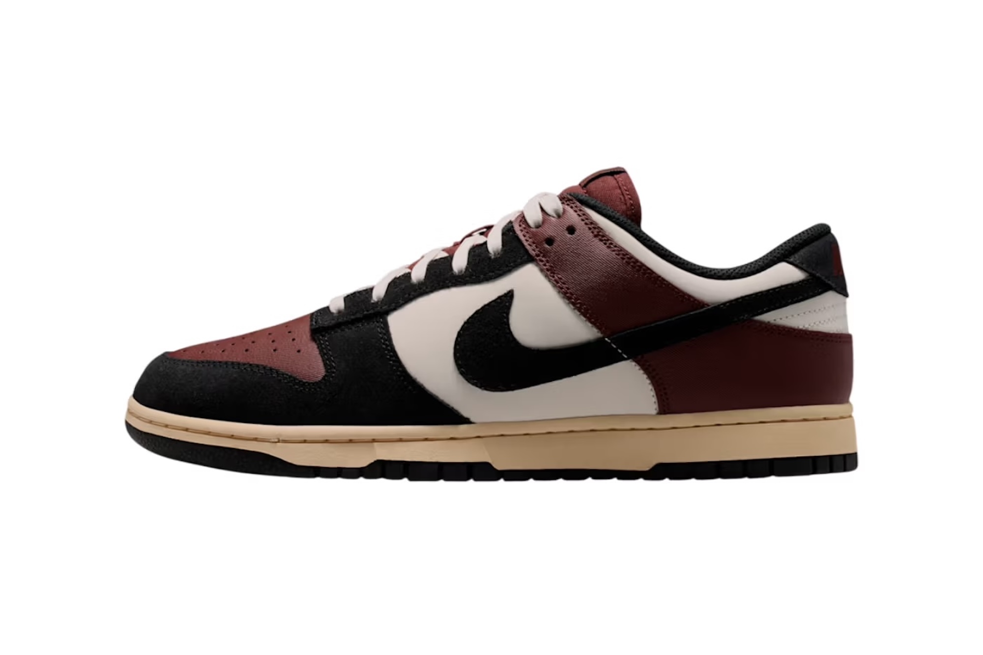 A pair of Nike Dunk Low sneakers in a burgundy, black, and white color scheme with a gum sole.