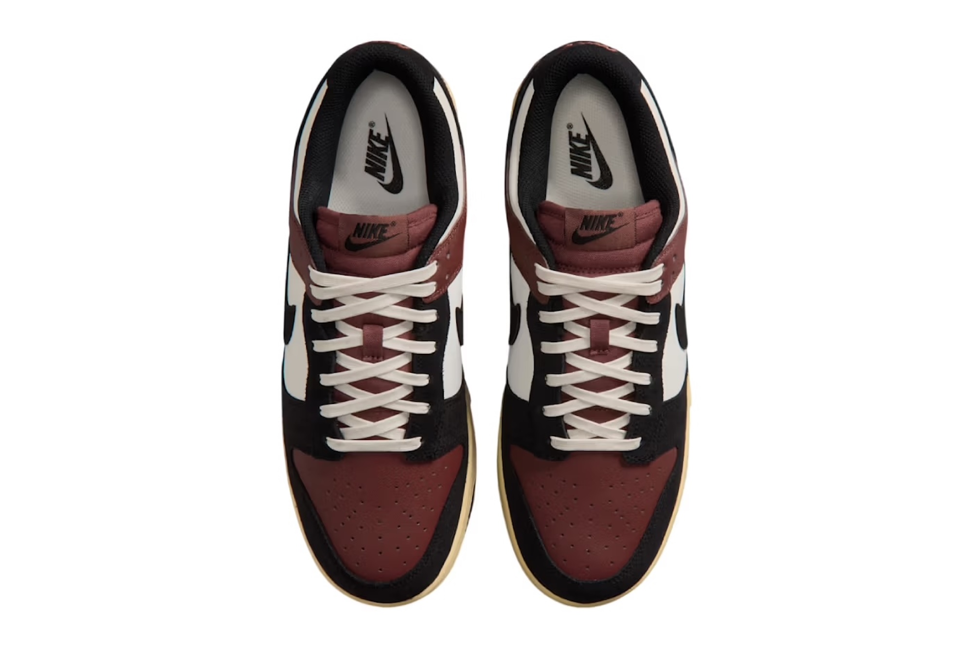 A pair of Nike sneakers in black, white, and burgundy with laces and the Nike logo visible.