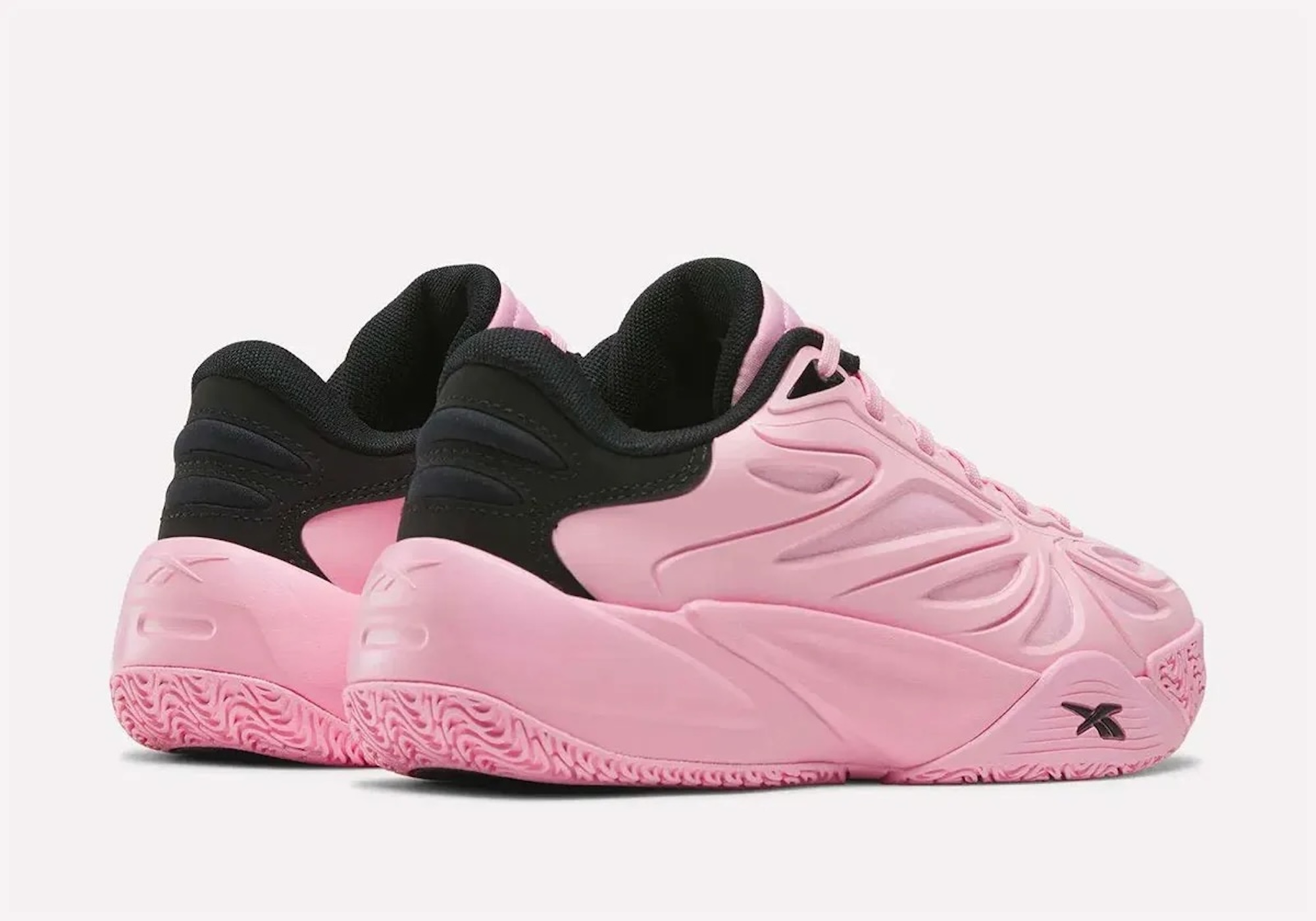 Pair of pink and black athletic shoes with a distinctive wavy design on the soles.
