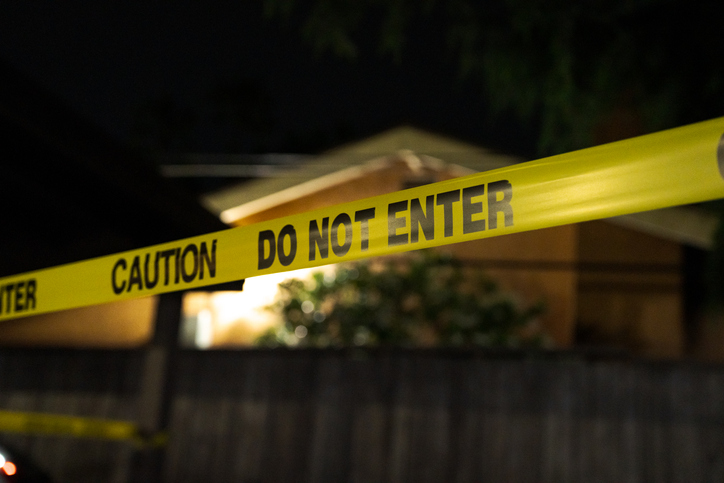 Yellow Do Not Enter Tape At Night Near Residential House