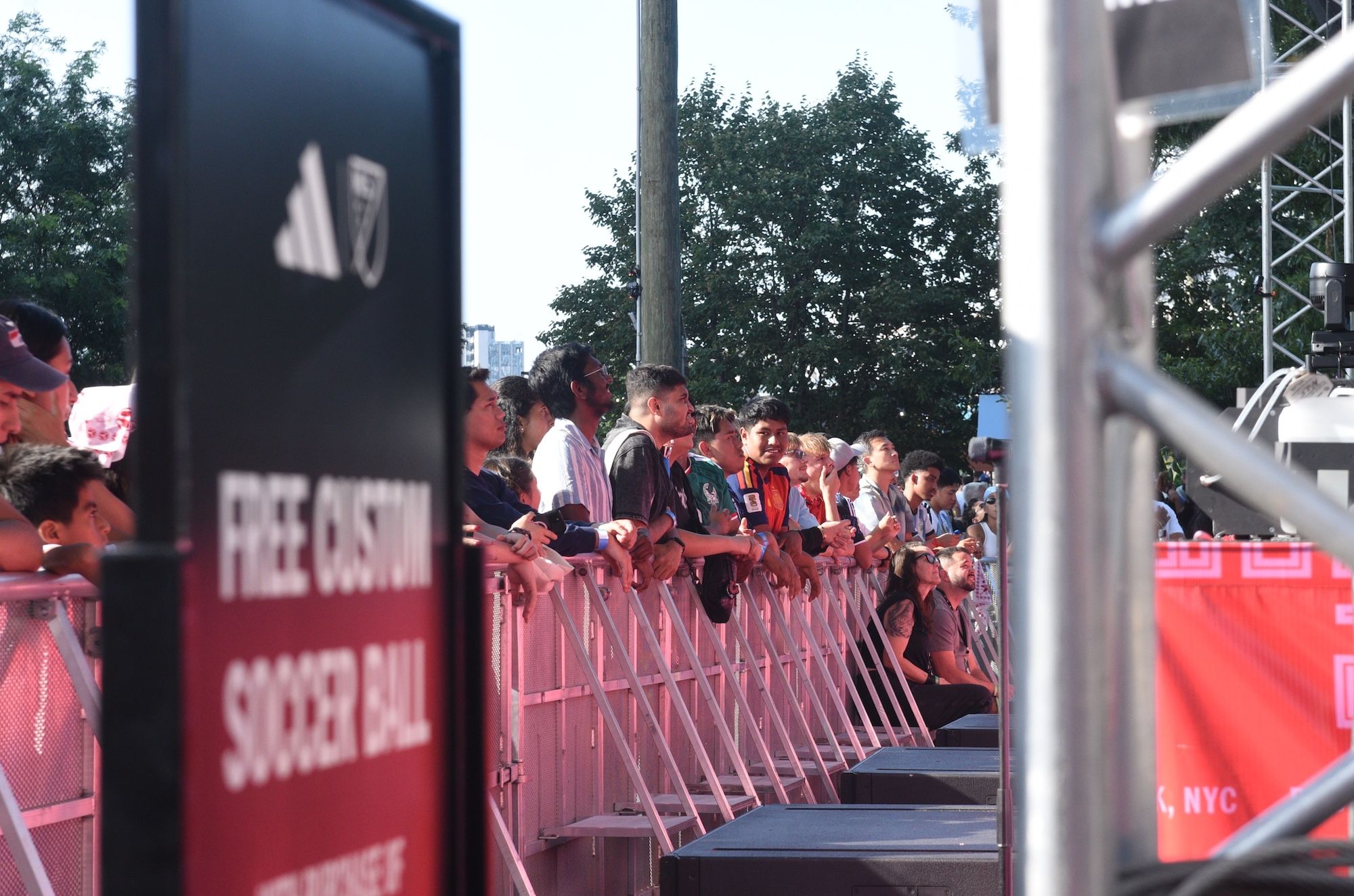 Crowd of people waiting in line at an event, with a "Free Austin" sign visible.