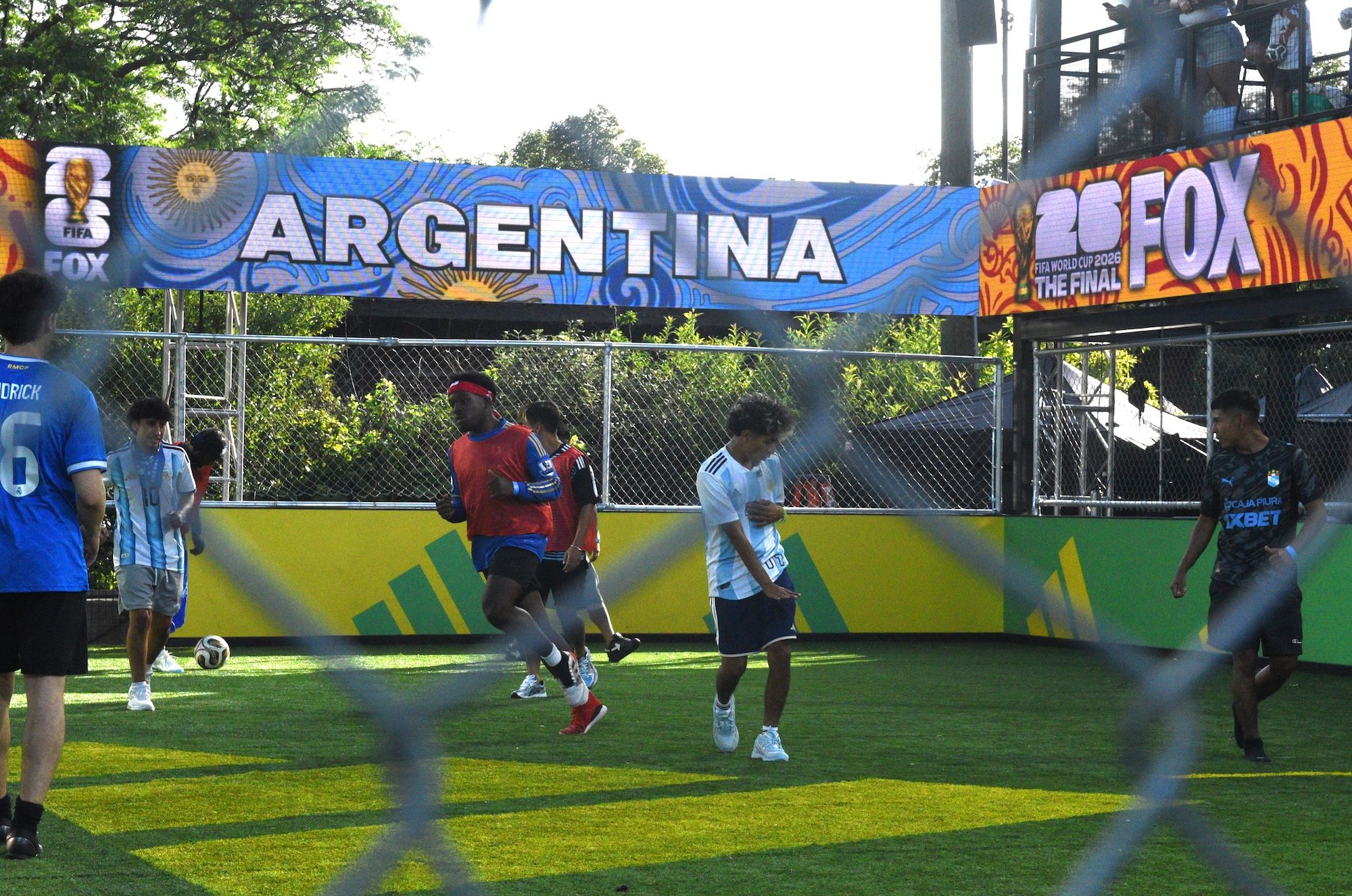 A soccer match taking place on a field with a large "ARGENTINA" banner and "FOX" branding visible.