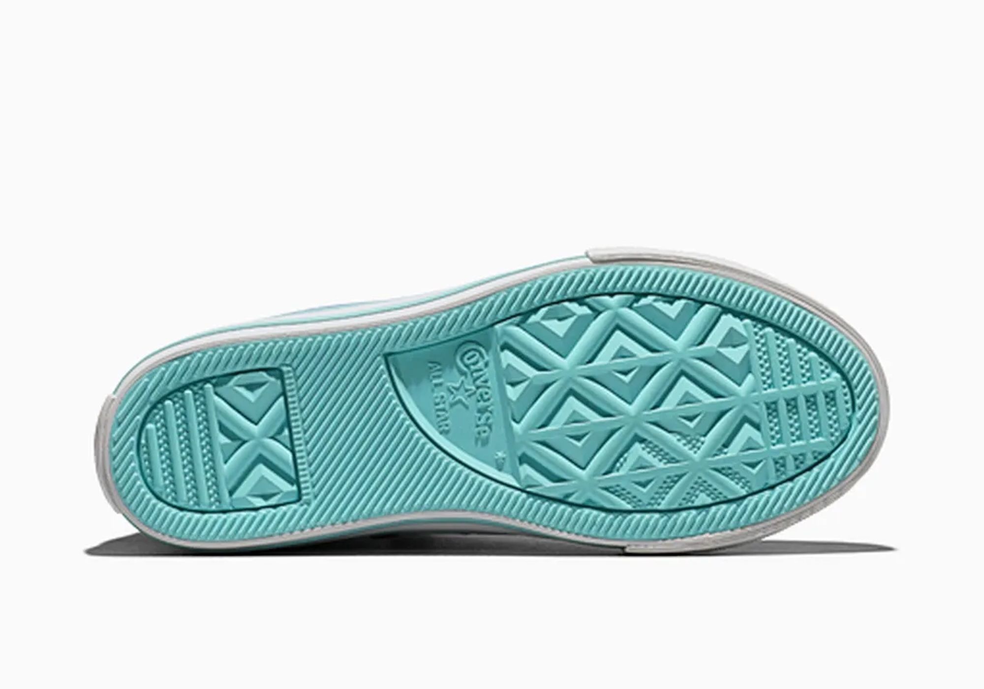 Teal-colored sneaker sole with textured pattern.