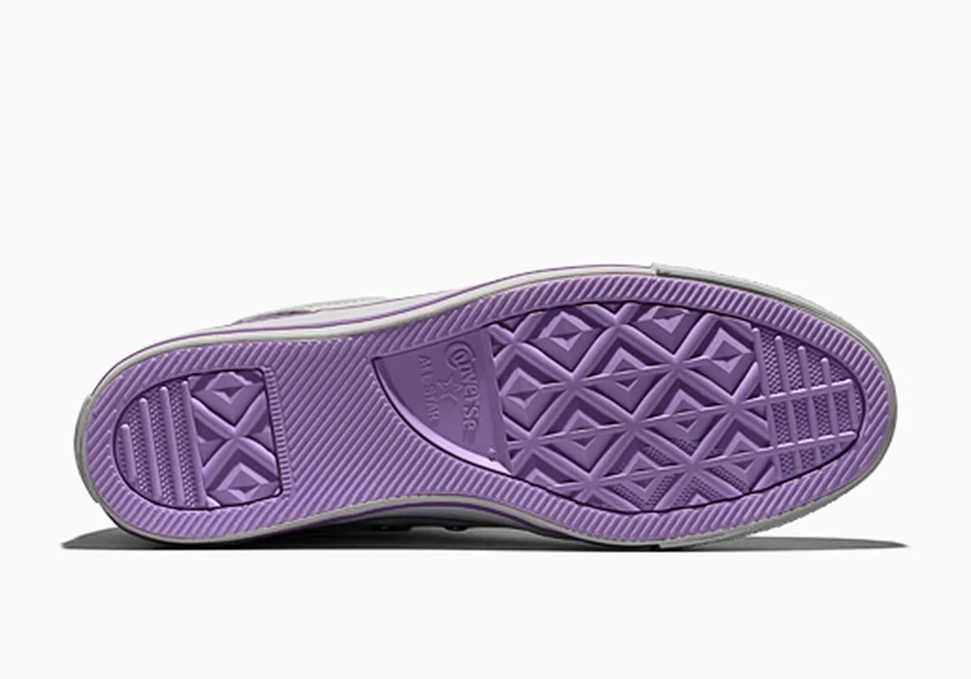 Purple sneaker sole with diamond-shaped tread pattern.