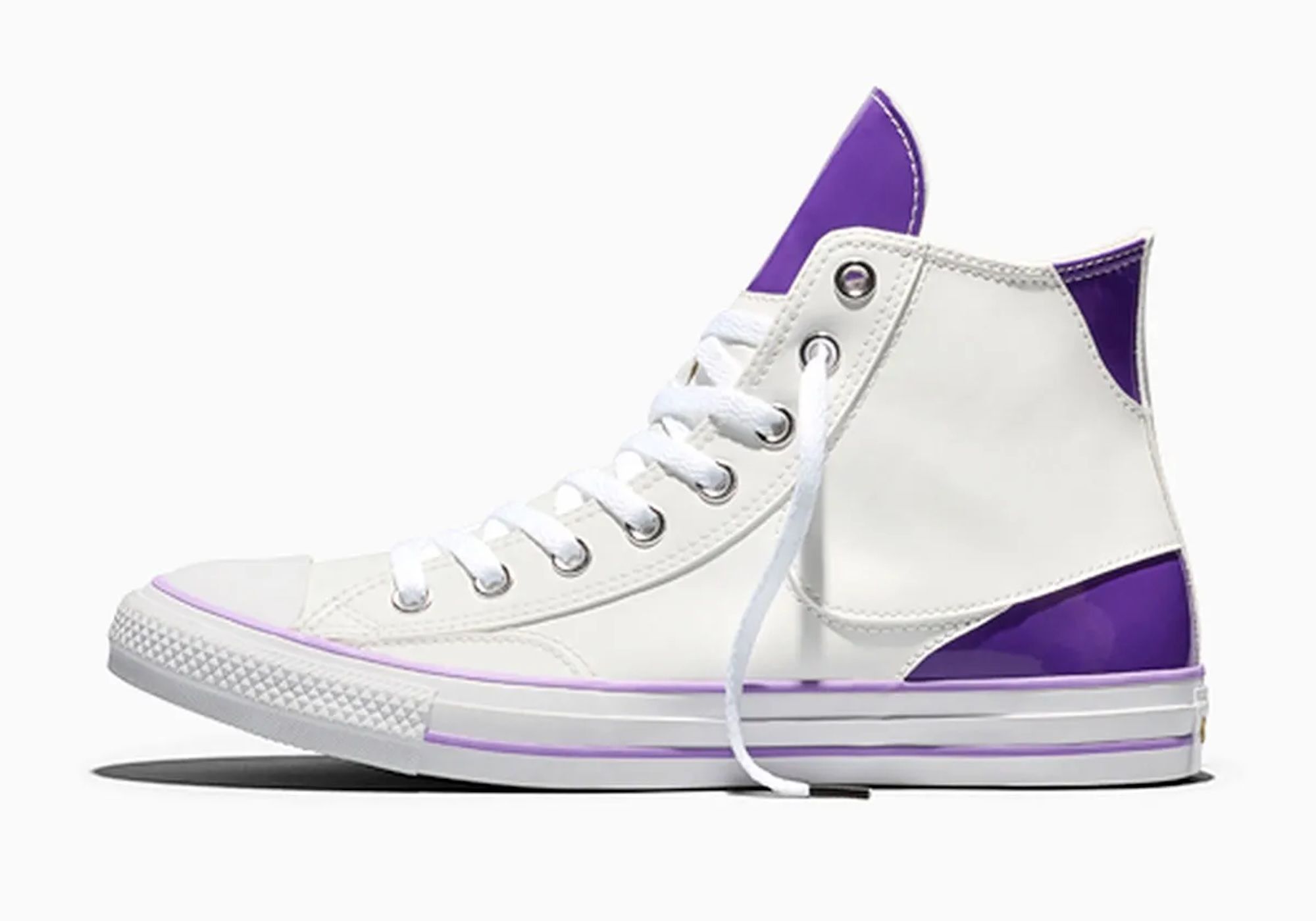A white and purple high-top sneaker with laces and a Converse logo on the side.