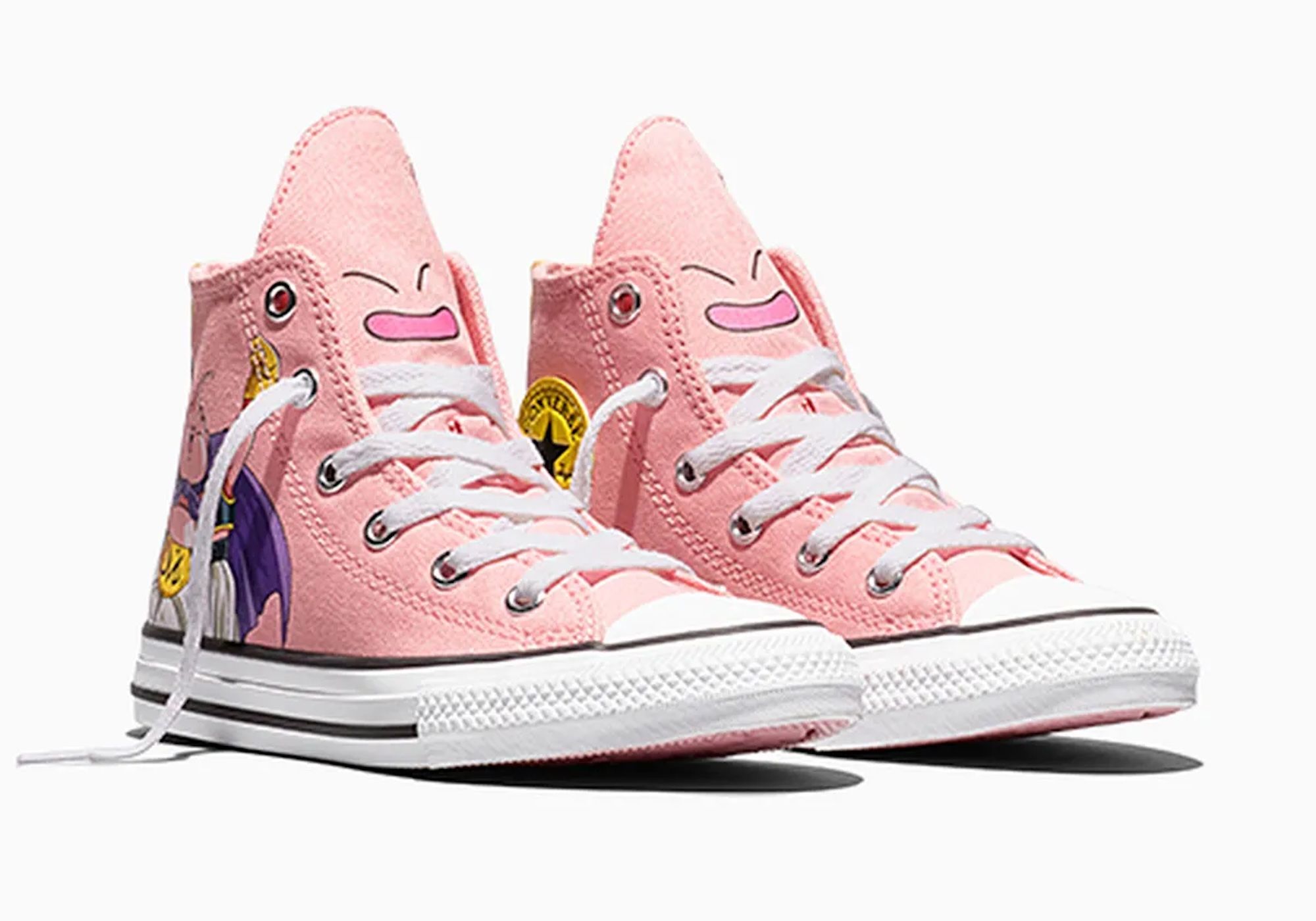 A pair of pink Converse-style sneakers with cartoon-style faces and decorative elements printed on the sides.